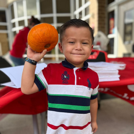 boy holding a small pumpkin